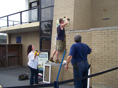 Patrick handles tools and panels, while juggling the level.